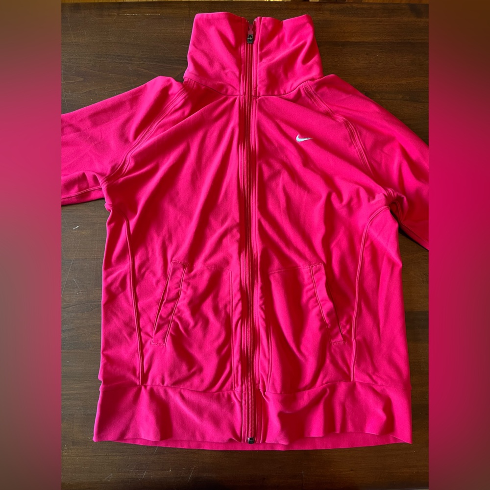 Nike Dry Fit long sleeve zip up. In used-good condition. Fuchsia in color